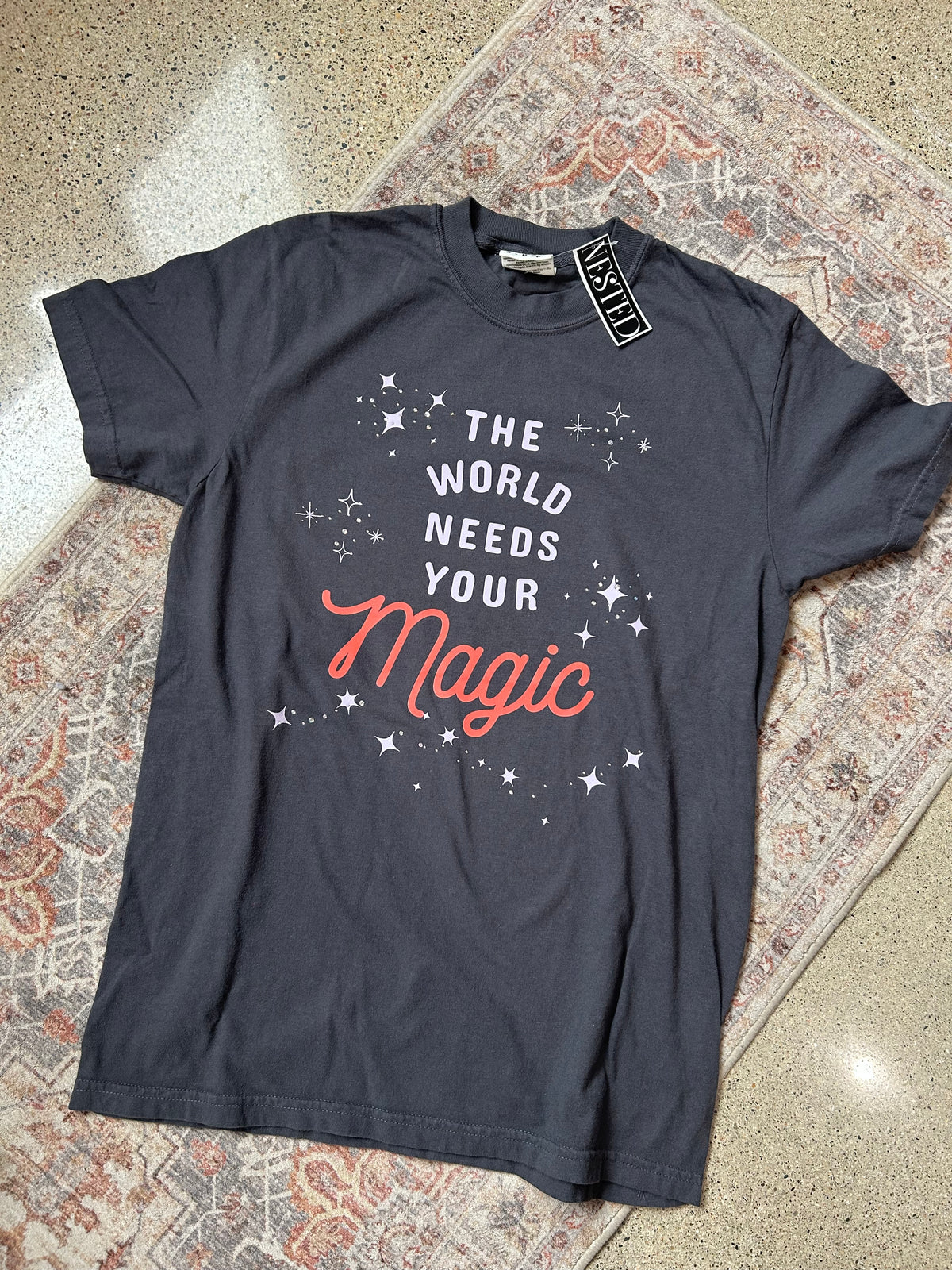 NK-The Wold Needs Your Magic Graphic Tee